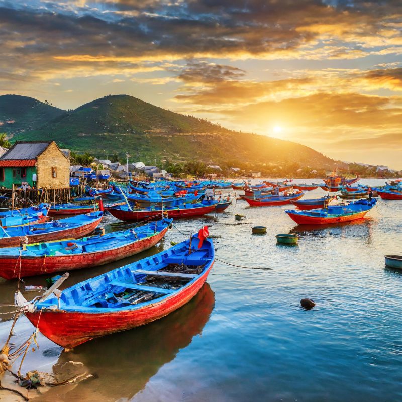Firefly vietnamese fishing village at sunset, with all boats painted blue with red hull 47077 Firefly vietnamese fishing village at sunset, with all boats painted blue with red hull 47077