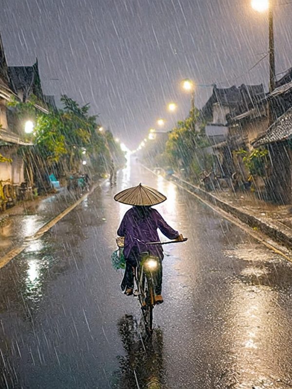 Vietnam old town at night with bicycle in rain