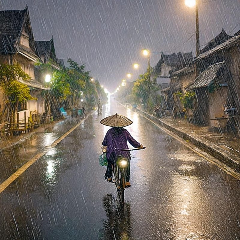 VN09 Vietnam old town at night with bicycle in rain