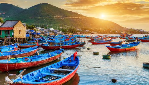 VN16 Vietnam fishing boats in port at sunset