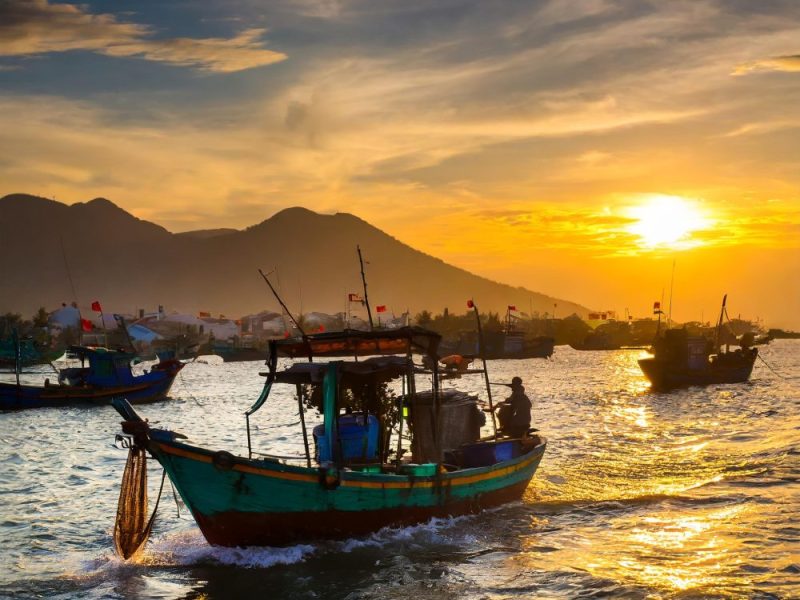 Vietnam fishing board returning to port at sunset